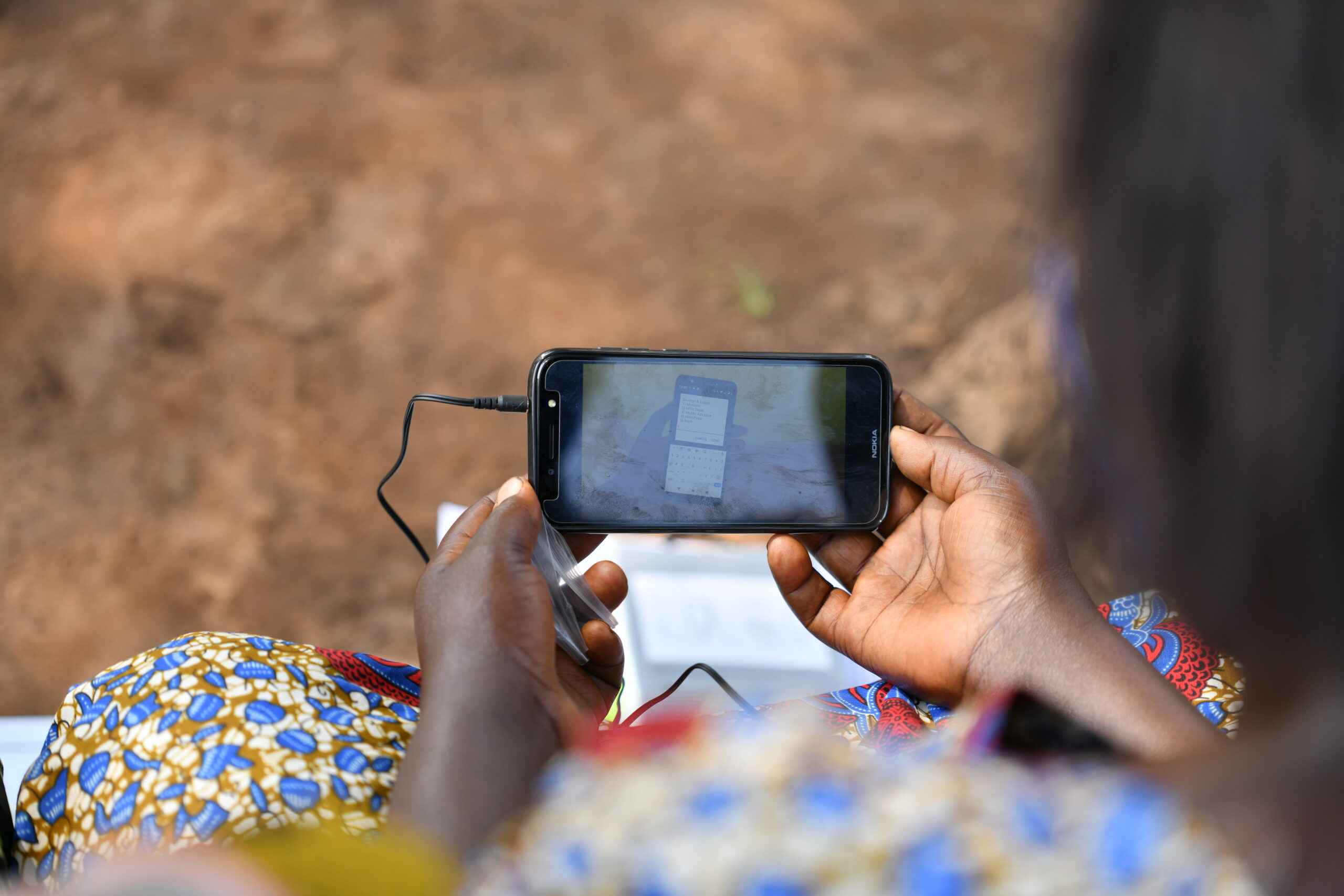 EQUALS participant uses a smartphone during digital literacy training.