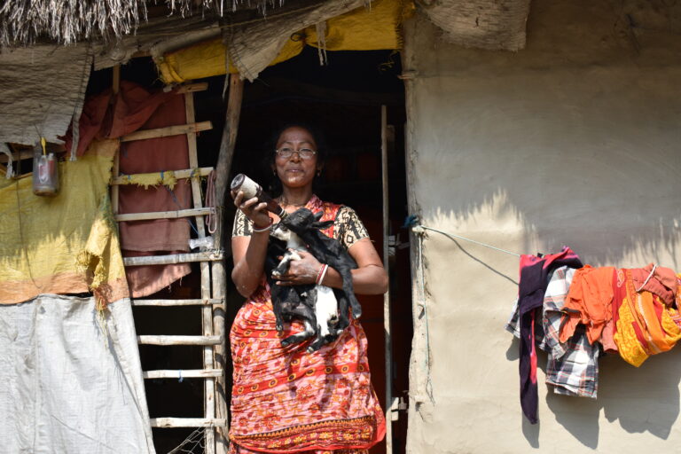 Trickle Up participant poses with a baby goat. She learned skills through our program that are helping her power her micro-enterprise and adapt to changing climates. Learn more through our International Women's Day panel.